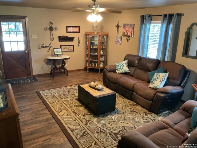 a living room with furniture and wooden floor