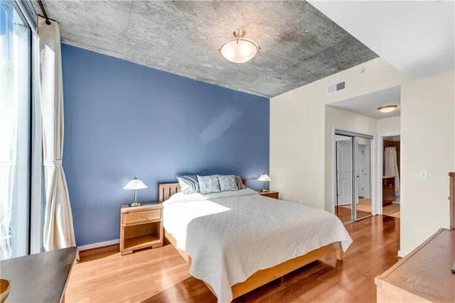 a bedroom with a bed and a chandelier