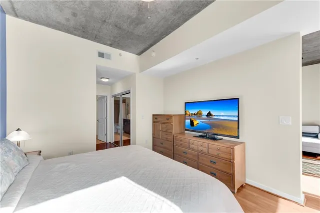 a bedroom with a bed and a flat screen tv