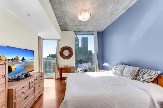 a bedroom with furniture and a flat screen tv