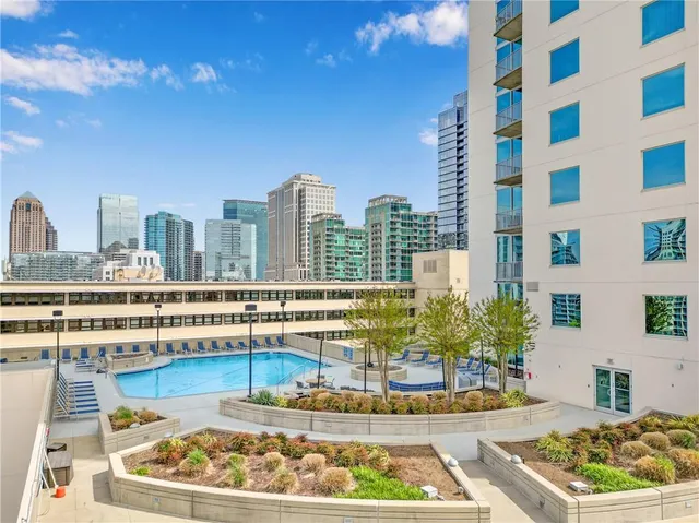 a view of swimming pool with outdoor seating and kitchen view