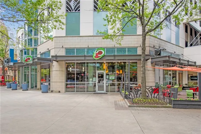 a street sign on a sidewalk next to a road