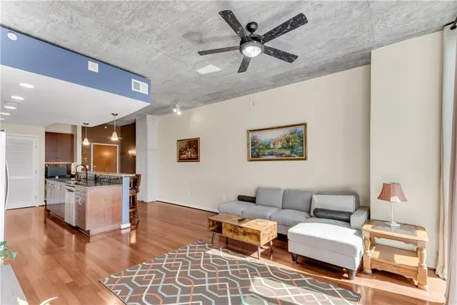 a living room with furniture and kitchen view