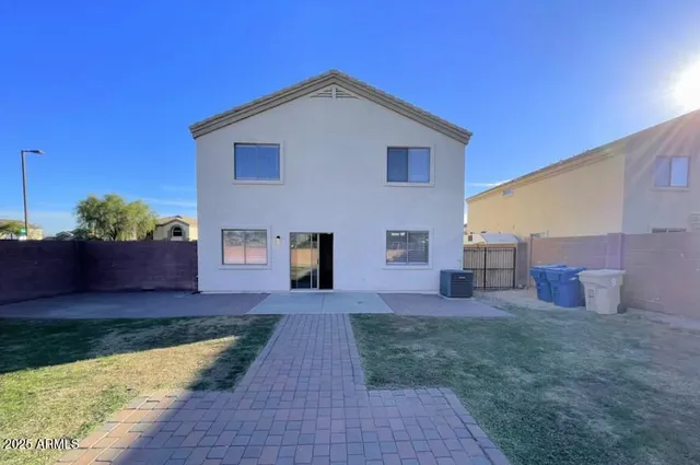 a front view of a house with a yard and seating space