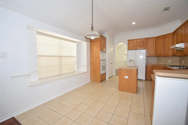 a view of a kitchen with a sink and a window