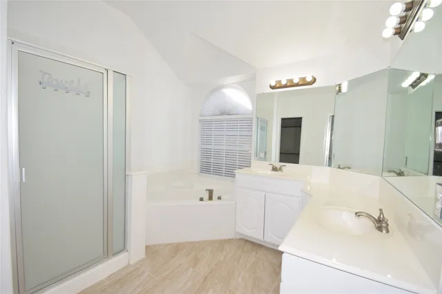 a bathroom with a bathtub sink and mirror