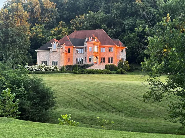 a front view of house with yard and green space