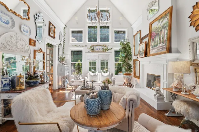 a living room with furniture a dining table and a potted plant