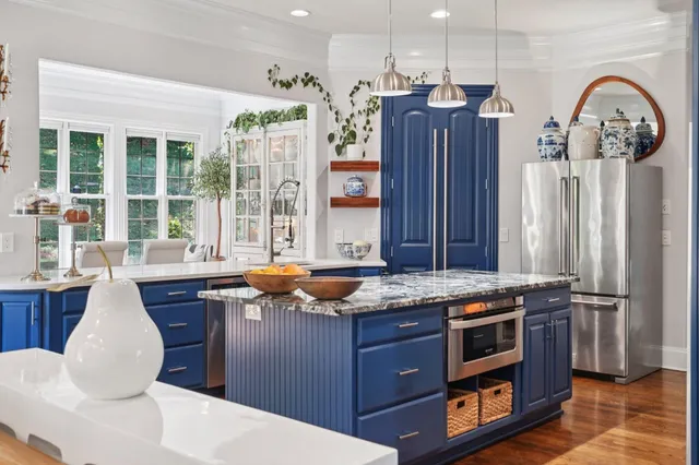 a living room with furniture and large windows