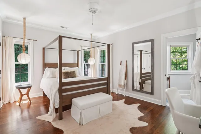 a front view of a house with a yard and potted plants