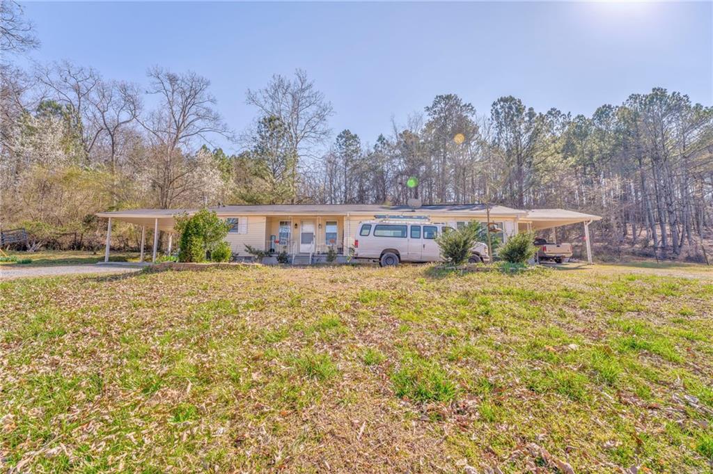a view of house with outdoor space and garden