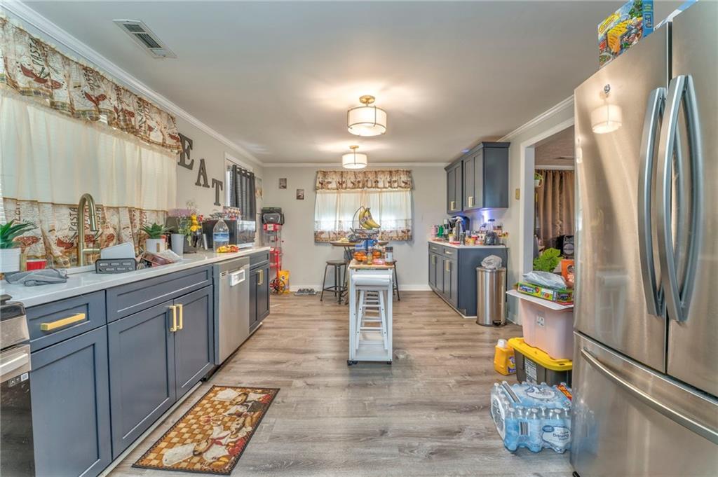 424 Wayside Road Rome, GA 30161 - Photo 2 of 16 a kitchen with stainless steel appliances granite countertop a refrigerator and a sink