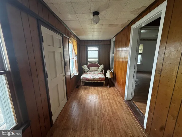 a view of a bedroom with wooden floor and staircase