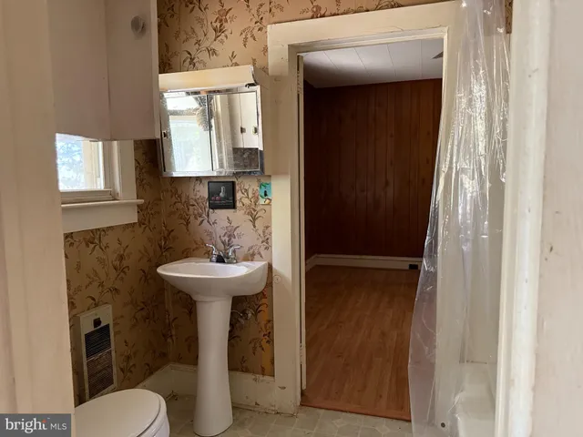 a bathroom with a sink toilet and mirror