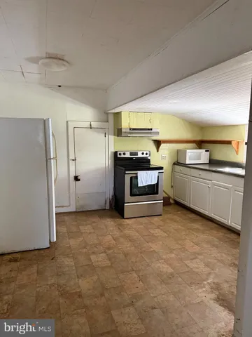 a view of a kitchen with a sink and an oven
