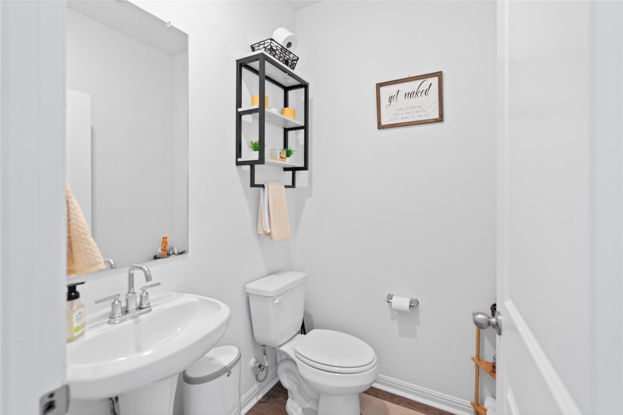 143 Santa Rosa Lane Buda, TX 78610 - Photo 25 of 28 Half bath with toilet and a sink
