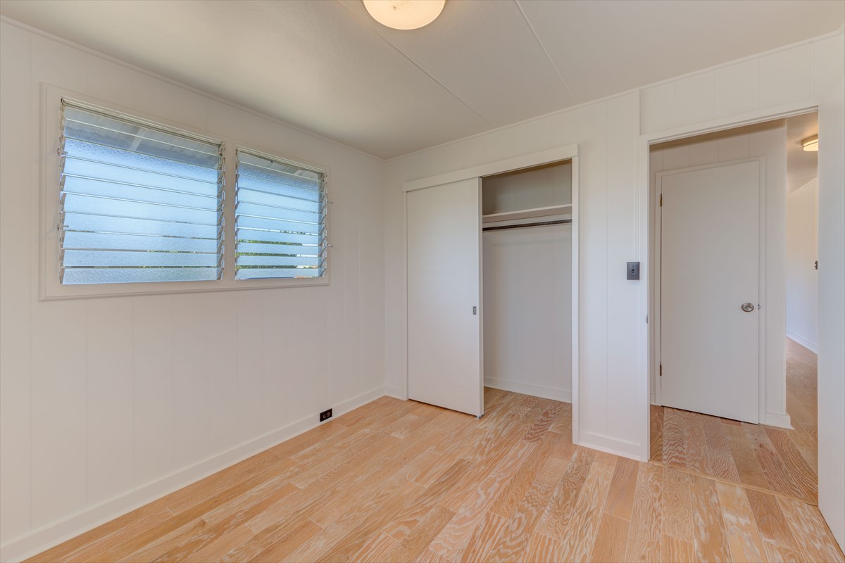 7921 Koae Road Kekaha, HI 96752 - Photo 13 of 25 a view of an empty room with wooden floor and a window