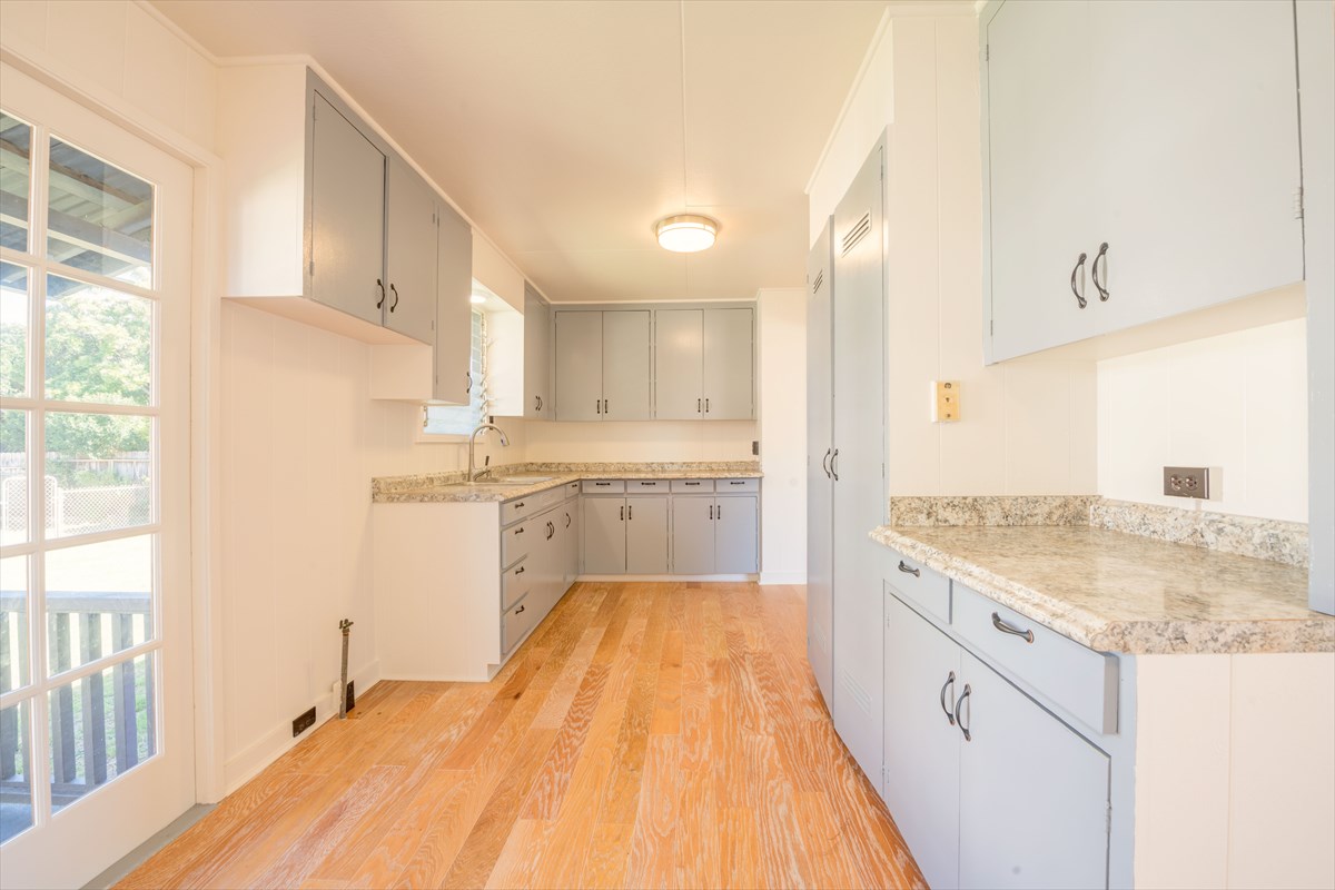 7921 Koae Road Kekaha, HI 96752 - Photo 7 of 25 a kitchen with granite countertop a sink cabinets stainless steel appliances and a window