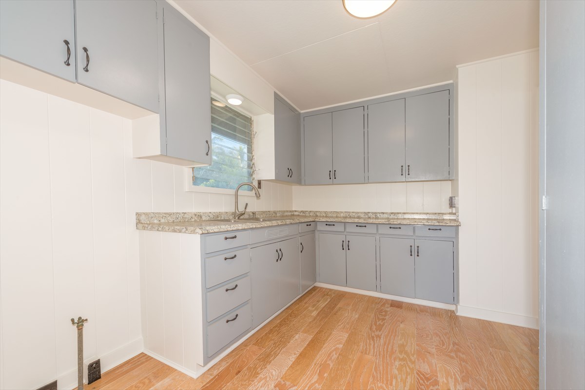 7921 Koae Road Kekaha, HI 96752 - Photo 8 of 25 a kitchen with granite countertop white cabinets and white appliances