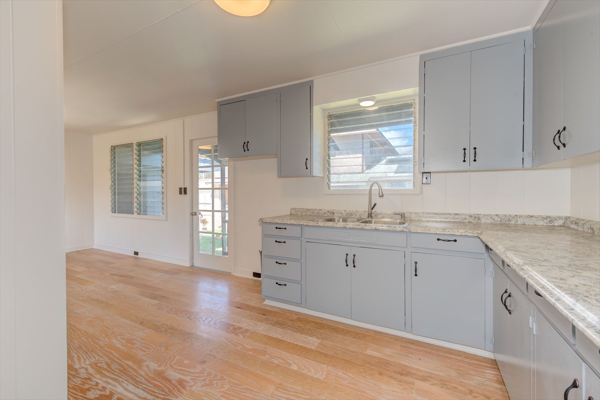 7921 Koae Road Kekaha, HI 96752 - Photo 9 of 25 a kitchen with granite countertop a sink stainless steel appliances and cabinets