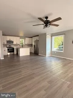 a view of a kitchen with a stove cabinets and wooden floor