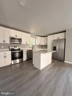 a kitchen with stainless steel appliances and a refrigerator