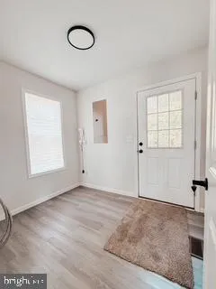 an empty room with windows and air conditioner vent