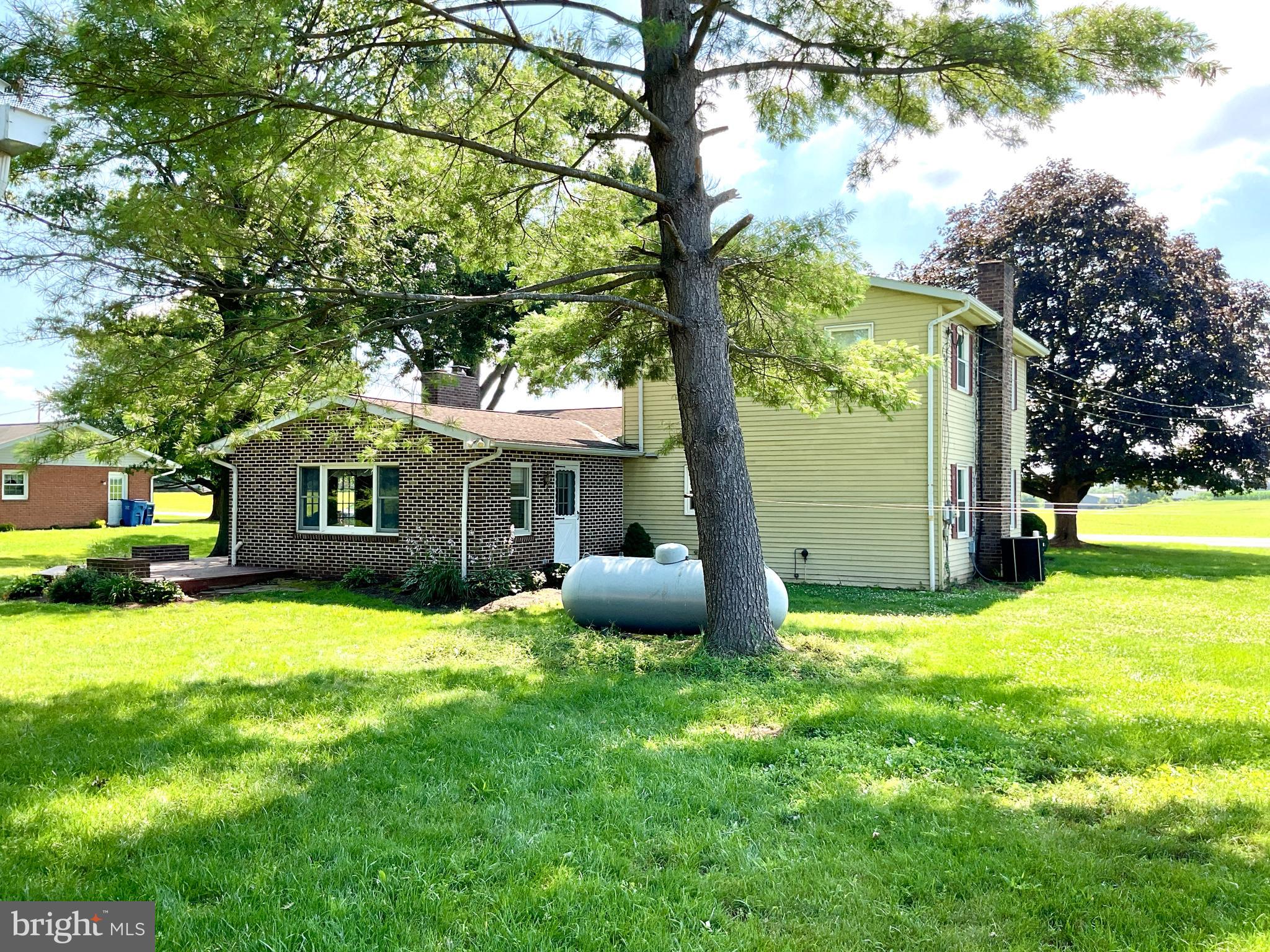 9 Buch Mill Road Lititz, PA 17543 - Photo 13 of 39 a front view of a house with a yard and trees