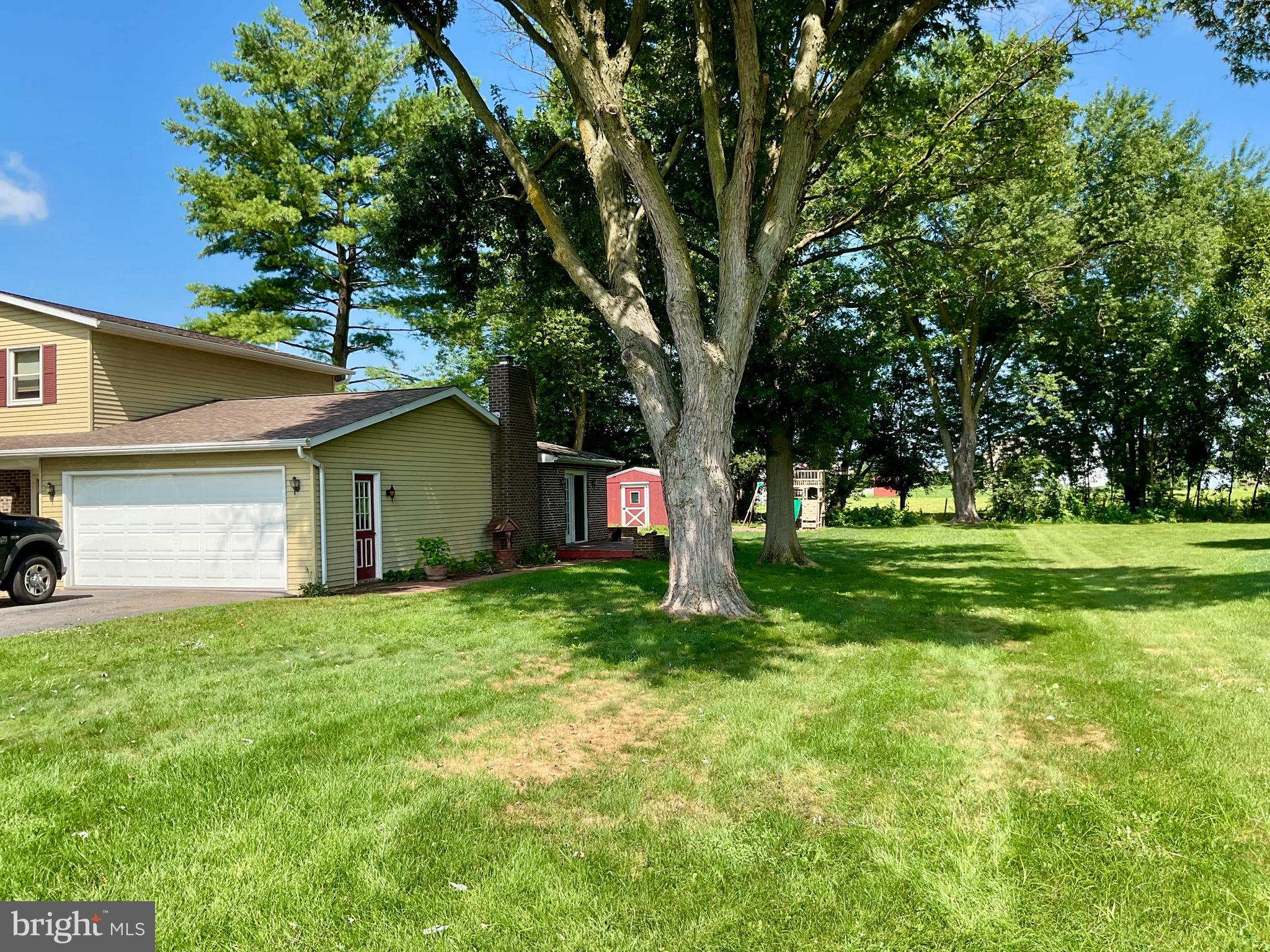 9 Buch Mill Road Lititz, PA 17543 - Photo 2 of 39 a yellow house in middle of the forest
