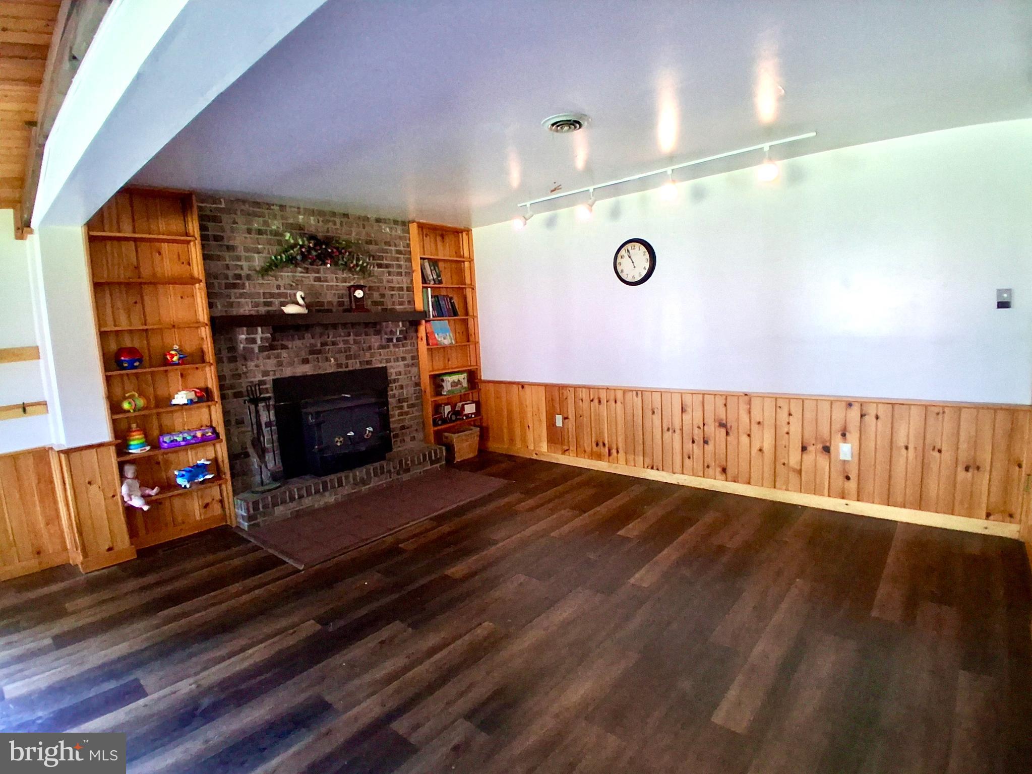 9 Buch Mill Road Lititz, PA 17543 - Photo 31 of 39 a view of an empty room with wooden floor and a fireplace