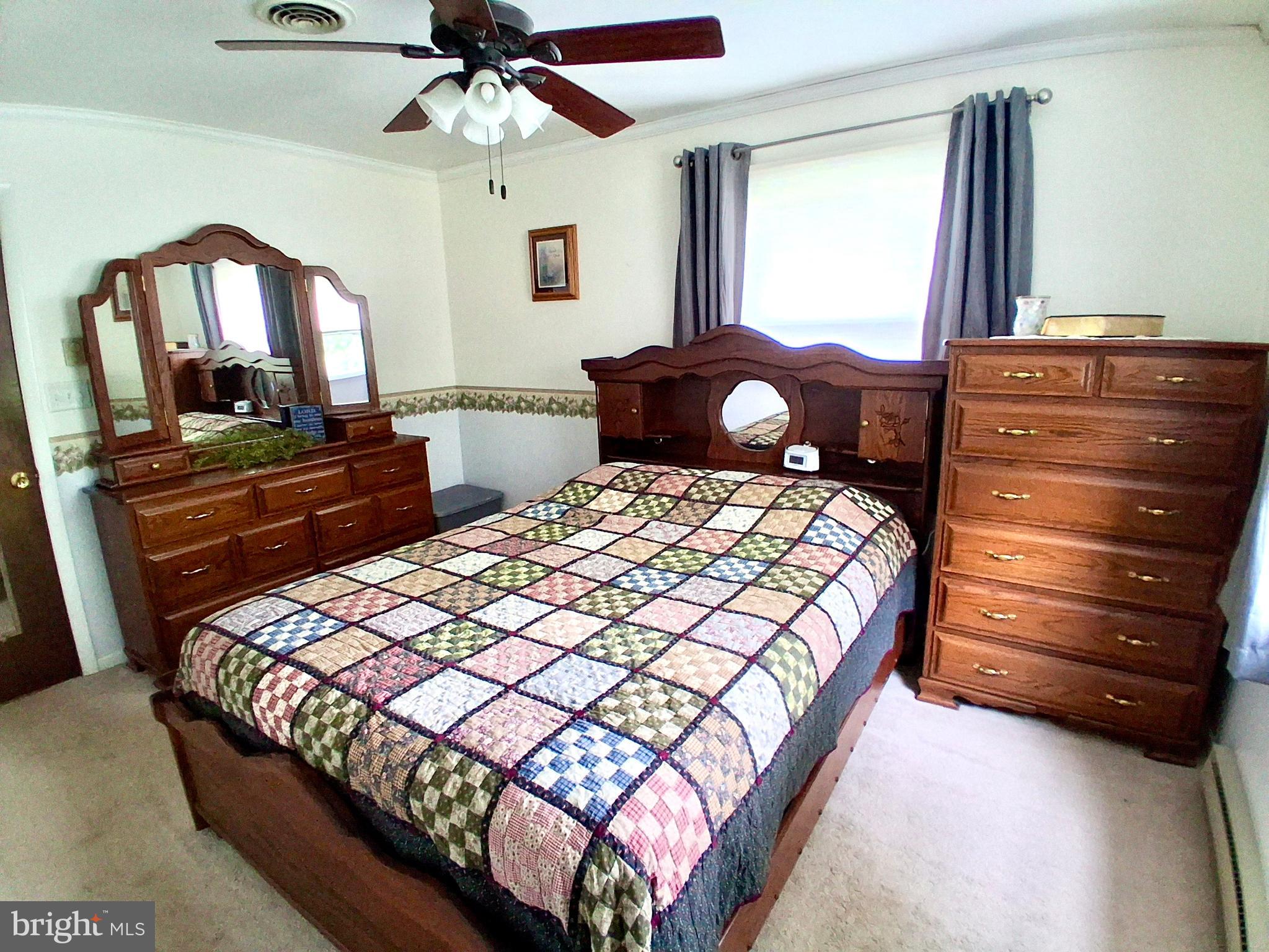9 Buch Mill Road Lititz, PA 17543 - Photo 36 of 39 a bedroom with a bed a dresser and a chandelier