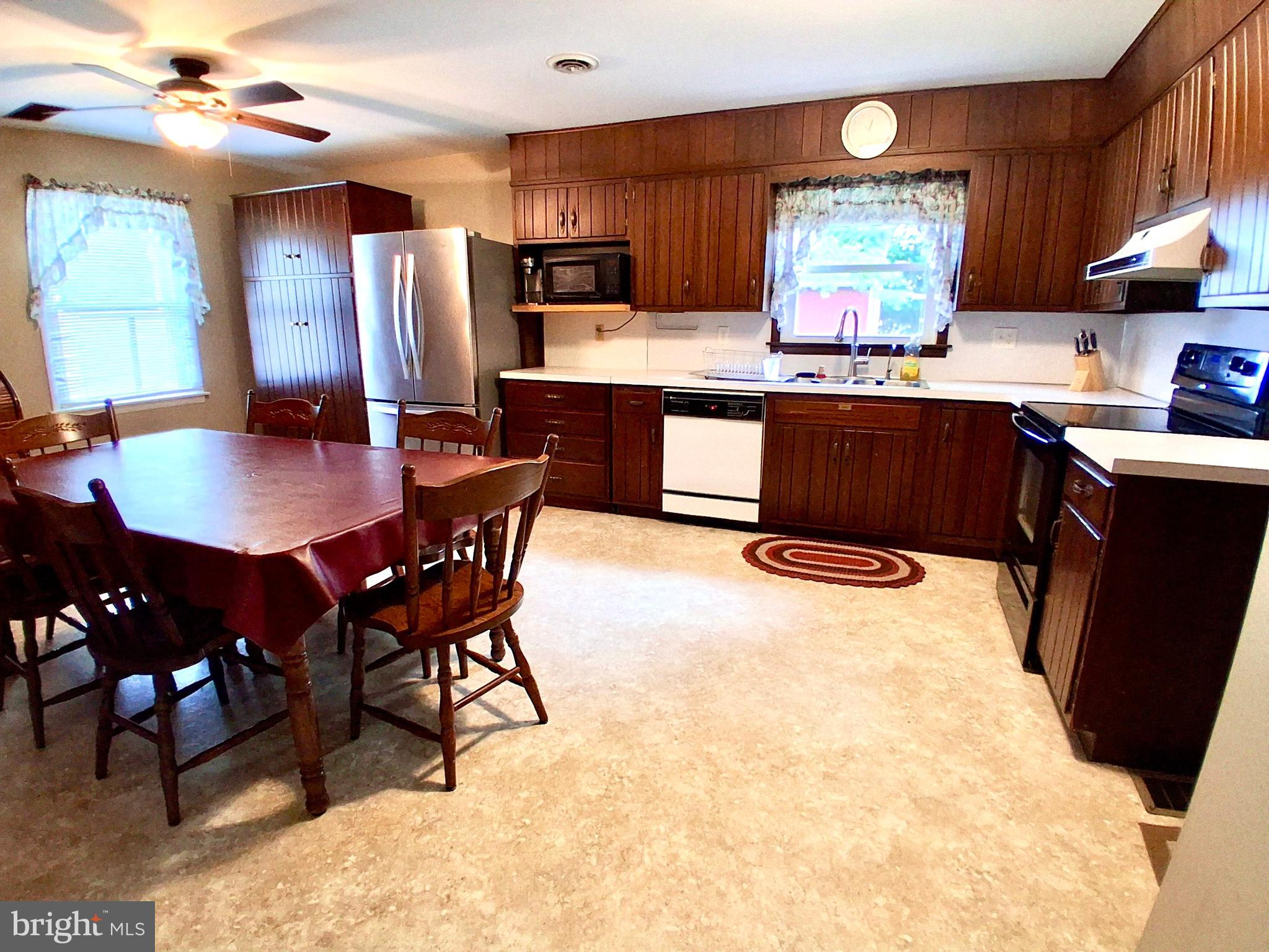 9 Buch Mill Road Lititz, PA 17543 - Photo 39 of 39 a kitchen with stainless steel appliances kitchen island granite countertop a table chairs sink and cabinets
