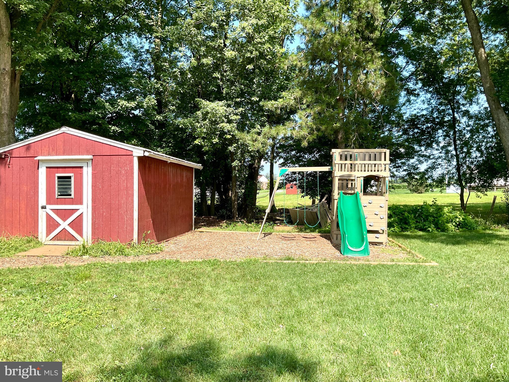 9 Buch Mill Road Lititz, PA 17543 - Photo 10 of 39 a front view of a house with a yard and trees