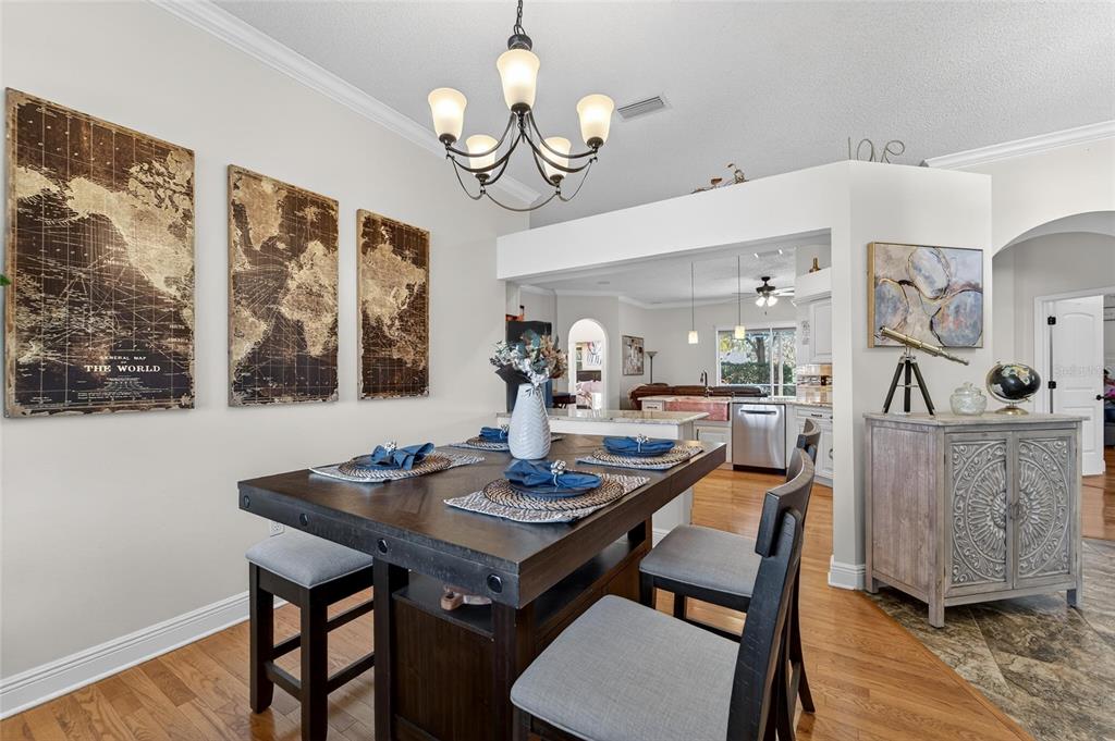 3522 Fox Squirrel Lane Valrico, FL 33596 - Photo 23 of 82 a view of a dining room with furniture a chandelier and wooden floor