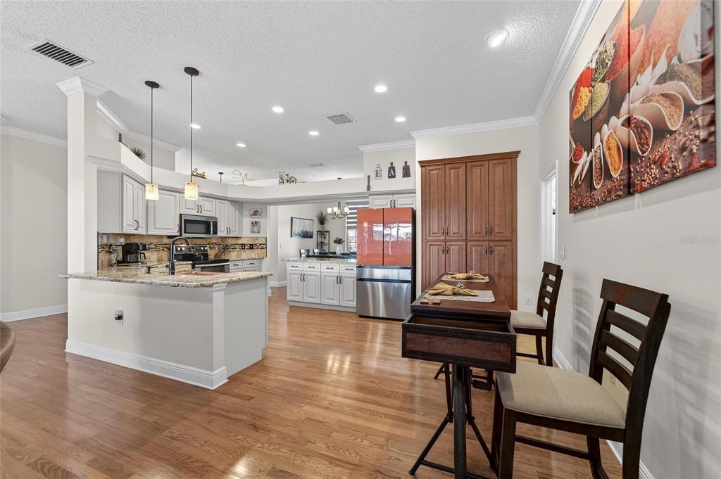 3522 Fox Squirrel Lane Valrico, FL 33596 - Photo 25 of 82 a kitchen with stainless steel appliances kitchen island granite countertop a refrigerator and microwave