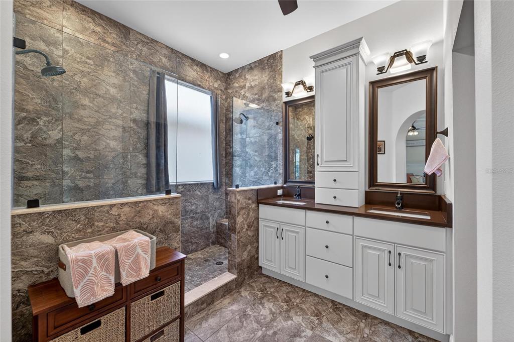 3522 Fox Squirrel Lane Valrico, FL 33596 - Photo 3 of 82 a spacious bathroom with a double vanity sink a mirror and a shower