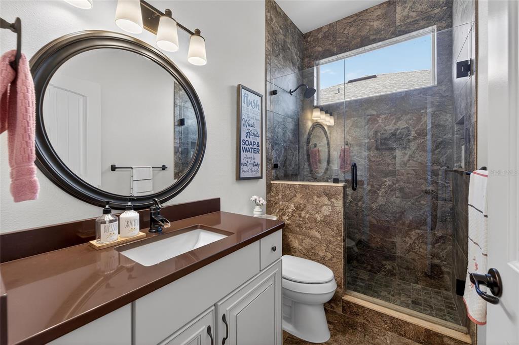 3522 Fox Squirrel Lane Valrico, FL 33596 - Photo 51 of 82 a bathroom with a sink a toilet and a mirror