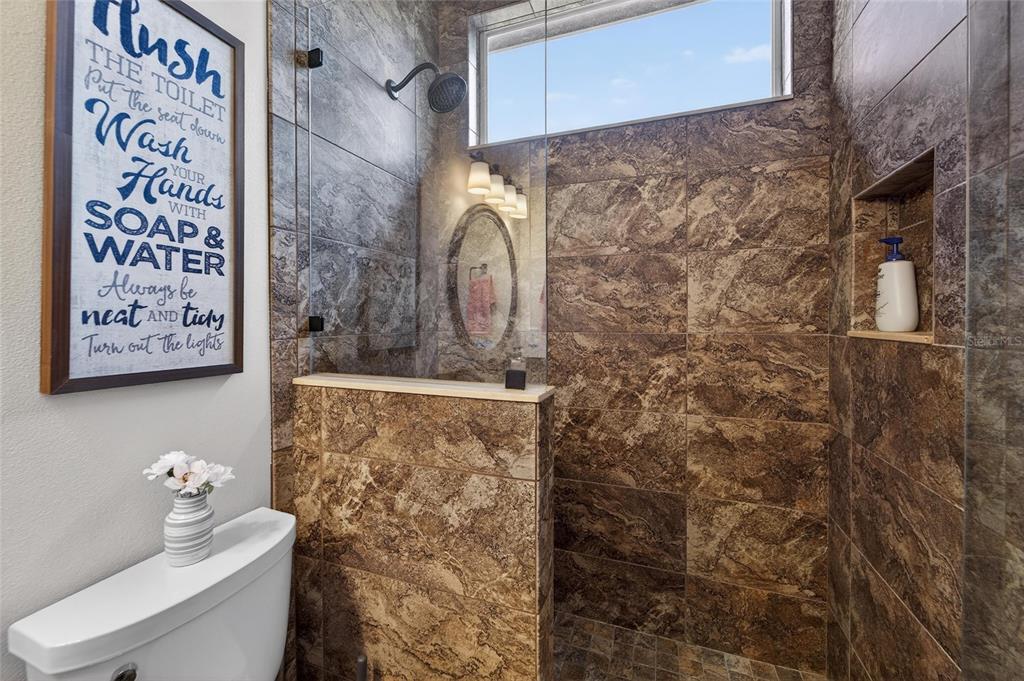 3522 Fox Squirrel Lane Valrico, FL 33596 - Photo 53 of 82 a bathroom with a toilet and a shower curtain
