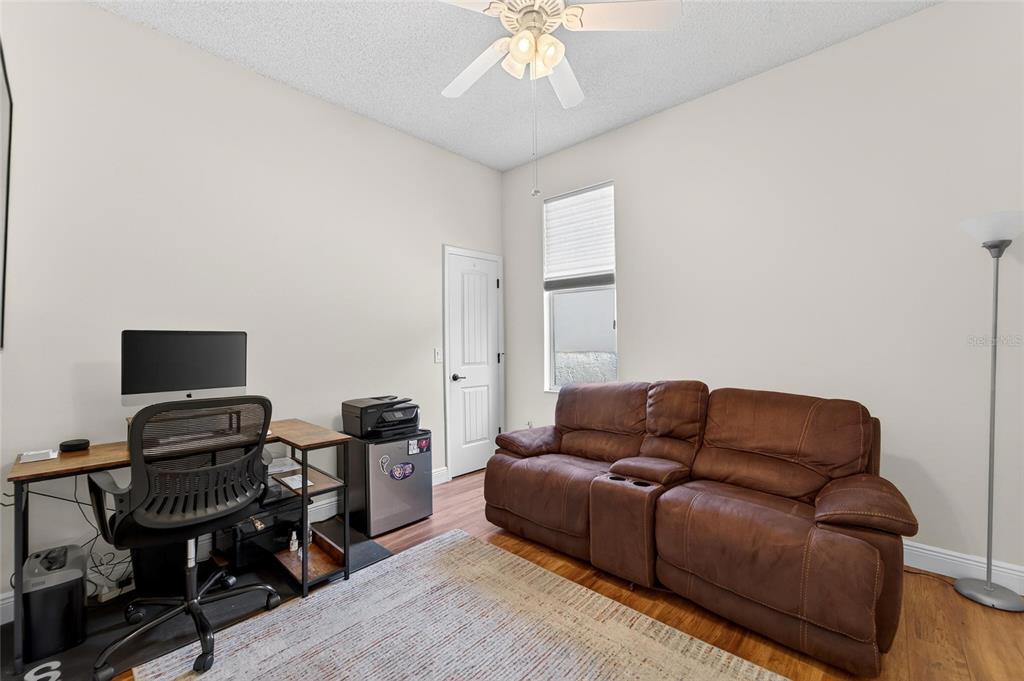 3522 Fox Squirrel Lane Valrico, FL 33596 - Photo 54 of 82 a living room with furniture a piano and a flat screen tv