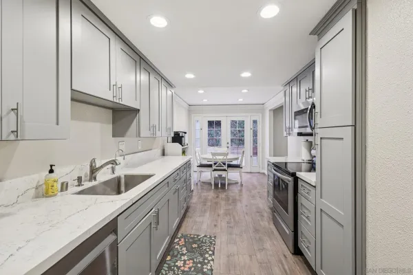 a kitchen with stainless steel appliances granite countertop a sink stove and refrigerator