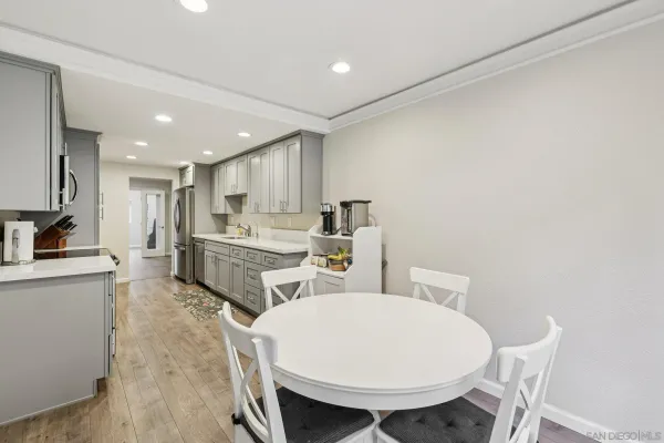 a kitchen with white cabinets and white appliances