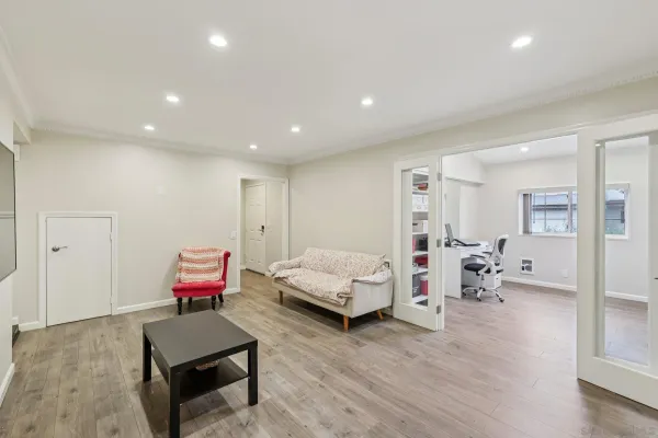 a bedroom with furniture and wooden floor