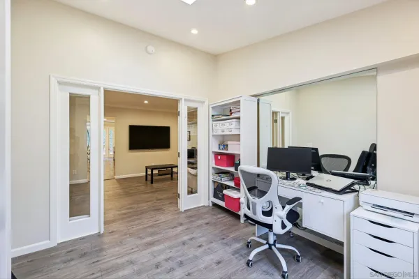 a view of a workspace with furniture and a window