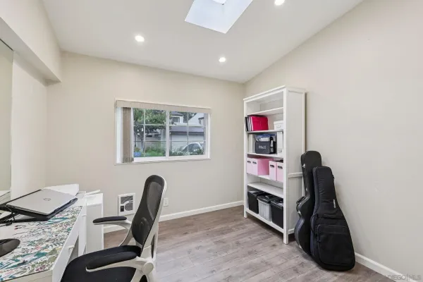 a view of a workspace with furniture and a window