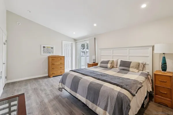 a bedroom with a bed and a night stand