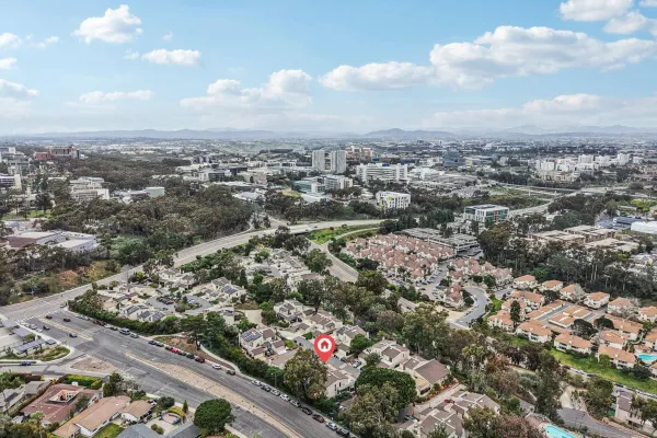 an aerial view of a house with a yard and balcony