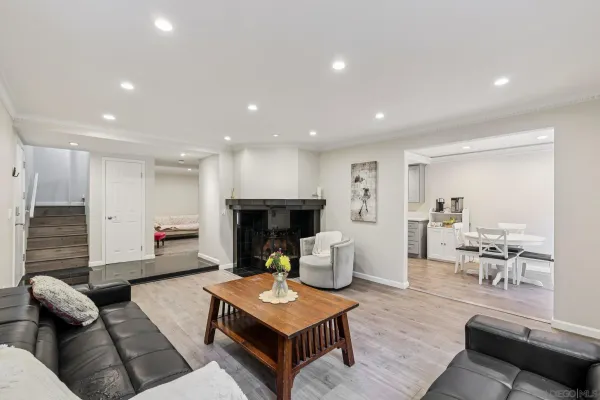 a living room with furniture fireplace and table
