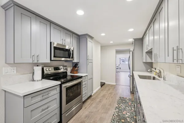 a kitchen with a sink stove and microwave