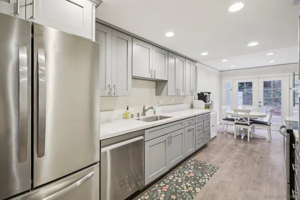 a kitchen with a sink stainless steel appliances and cabinets