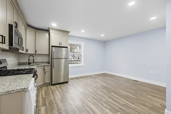 a kitchen with a refrigerator and a stove top oven